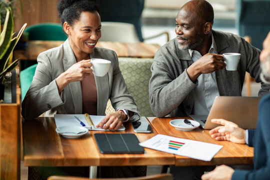 Business colleagues having coffee meeting at cafe