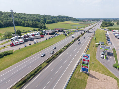 30 May 2026, Rotselaar, Belgium. Aerial drone view of E314 highway with traffic flow, service station and roadside fuel price sign