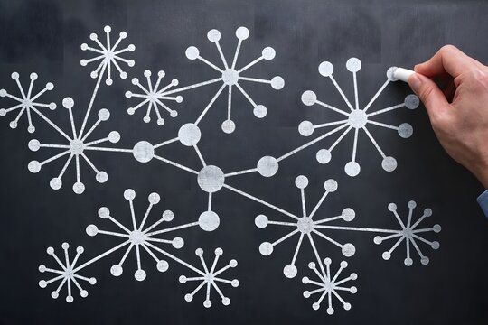 Knowledge graph. Visualization of semantic network structure. Organizing relationships between data and information. Consultant teaching how to draw diagram on blackboard.