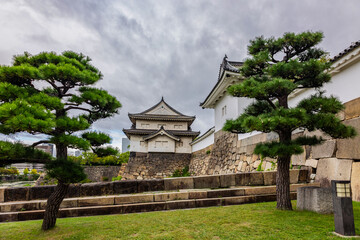 Naklejka premium Elevated stone embankment surrounding Osaka Castle in Osaka Japan during calm overcast weather, Osaka Japan