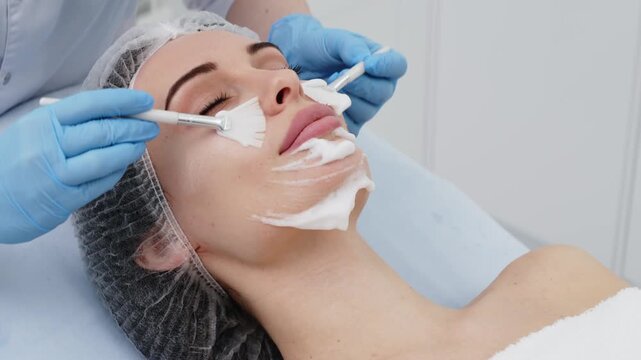 Woman undergoing hydrafacial procedure in aesthetic beauty center. Concept facial cleansing, hydration and cosmetology.
