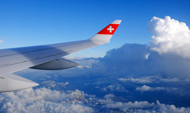 SWISS Airlines Airbus A220 wing, clouds and mountains