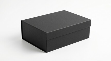 Naklejka premium A black rectangular box with a lid is sitting on a white surface indoors.