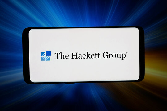 Stuttgart, Germany - 05-20-2026: In this photo illustration, the logo of US AI strategy company The Hackett Group Inc. is displayed on a smartphone in front of abstract background on computer screen.