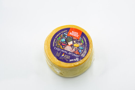 Hanul Boieresc Cascaval Afumat cheese wheel closeup on white.