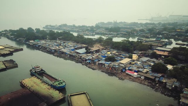 Aerial view of Sewri village near the Dockyard area in Mumbai, India, capturing a striking contrast between traditional coastal settlements and industrial port infrastructure.