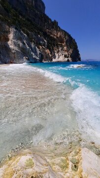 stunning beach view featuring turquoise water and dramatic cliffs at costa baunei