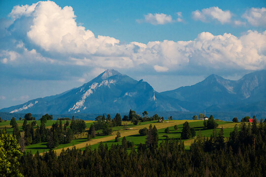 Scenic view of majestic Belianske Tatra mountains and green hills