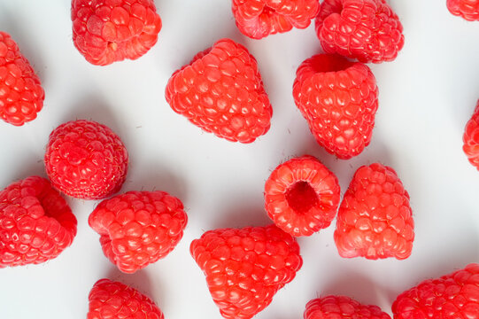 Raspberry background. Raspberries on a white background. Fruits on the table