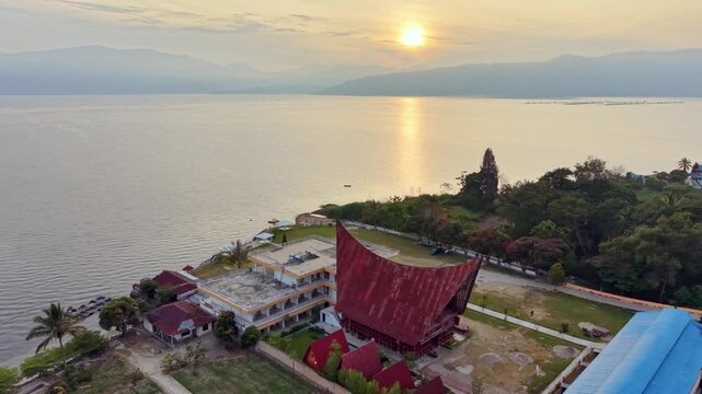Seaside Temple At Twilight. Dusk Casts Golden Glow On Tranquil Coastal Temple Scene With Mountains