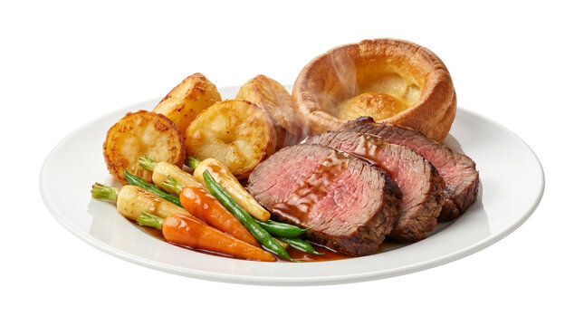 Traditional roast beef dinner with Yorkshire pudding, roasted potatoes and glazed vegetables, gourmet sliced medium-rare beef roast on a white plate isolated PNG with Transparent Background