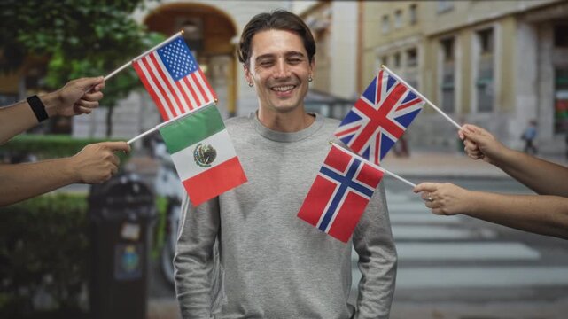 Man smiles with eyes closed as multiple national flags are waved around him on a street; solidarity joy.