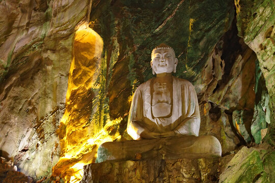 Stone Buddha statue inside the sacred Huyen Khong Cave, Marble Mountains in Da Nang, Vietnam