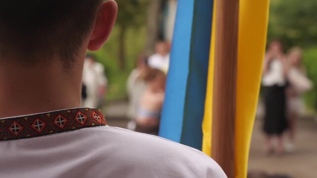 Ukrainian boy standing with the flag of Ukraine