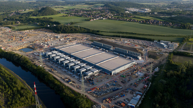 Aerial drone view of hyperscale data center construction in Farciennes, showing high tech cloud, big data, AI infrastructure and power systems.