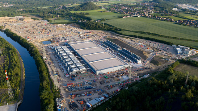 Aerial drone view of hyperscale data center construction in Farciennes, showing high tech cloud, big data, AI infrastructure and power systems.
