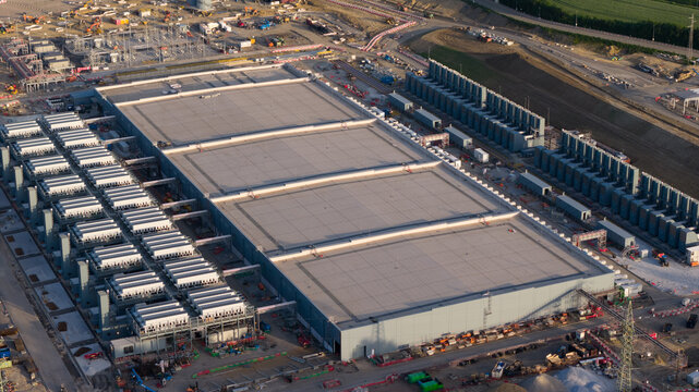 Aerial drone view of hyperscale data center construction in Farciennes, showing high tech cloud, big data, AI infrastructure and power systems.