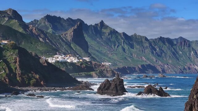 Roque de las Animas sea stack above Almaciga village and Benijo coast in Anaga Rural Park, Tenerife, Canary Islands. Aerial video.