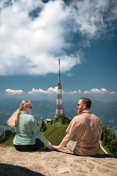 Couple admiring the technology and infrastructure of the telecommunication tower "Sender Gr&uuml;nten" on the &Uuml;belhorn near Sonthofen, ideal for broadcasting technology marketing