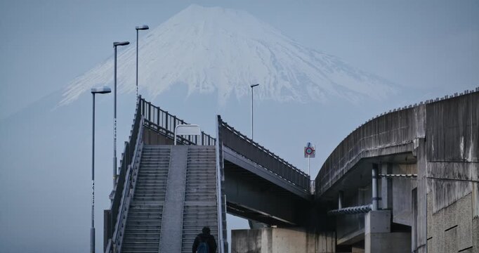 Person walking up steps with majestic, hazy view of mount fuji - low shot