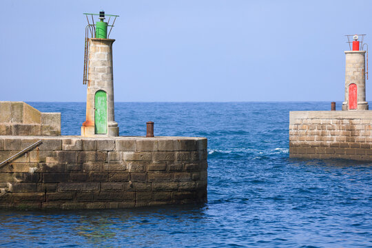 Signaling pier beacons in the fishing port of Tapia de Casariego town, a small fishing village in Asturias