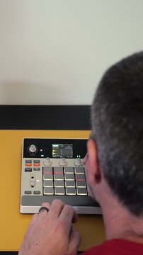 Music producer hands tapping drum pads hardware sampler making hip hop beats electronic music production sequencing audio finger drumming workstation