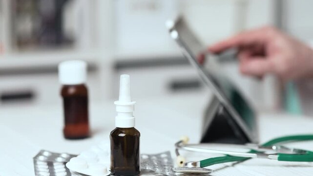 Doctor Typing on Tablet and Filling Digital Medical Record in Hospital Clinic with Focus on Pills