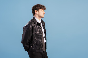Side profile portrait of stylish young man in leather jacket posing in studio © Maria Vitkovska