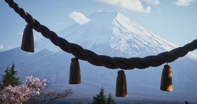 Large torii gate rope in front of hazy view of mt. fuji - locked off shot