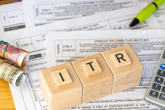  India taxes. Various ITR forms to fill out. Income tax return. Annual tax declaration. Financial concept. ITR written on wooden blocks. Close up