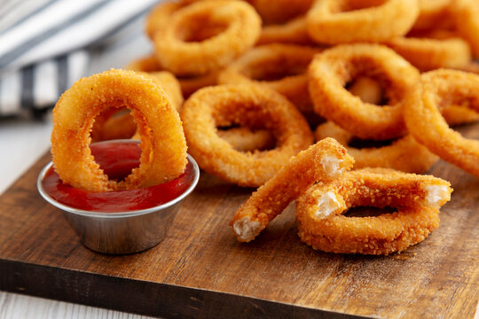 Homemade Fried Onion Rings with Ketchup, side view. Close-up.