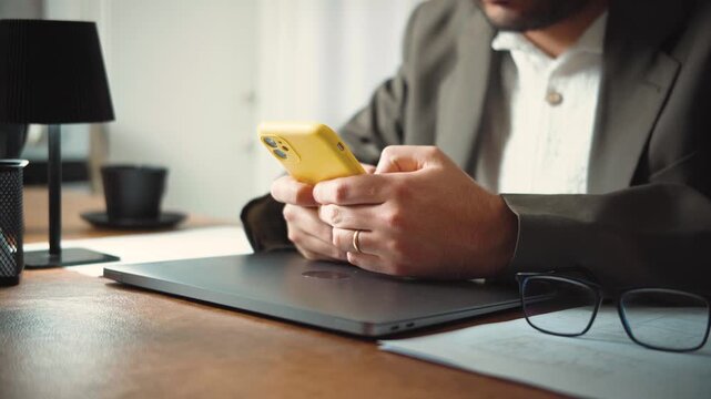 Video of a businessman in his office answering a phone call from a client. Professional communication, customer relations and business management concept.
