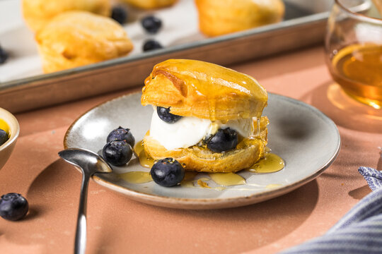 Scone Filled with Blueberry  and Clotted Cream on a plate