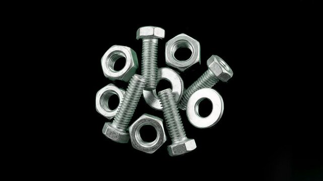 A metallic pile of iron bolts, hex nuts, and flat shiny washers is arranged neatly over a solid black backdrop. Designed as a high-quality 3D render for industrial construction tools, engineering hard