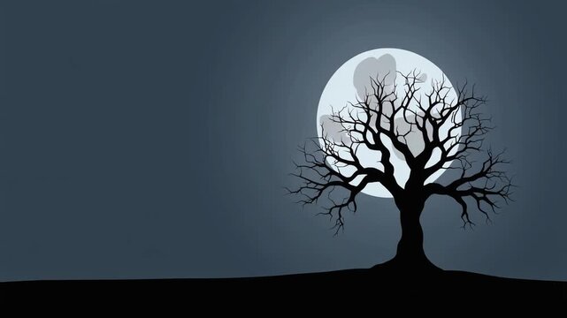 A spooky silhouette of a bare tree standing against a large full moon at night.