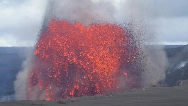 View of a powerful volcanic eruption with glowing lava and ash clouds at Halema'uma'u Crater in Hawaii county, Hawaii, United States.