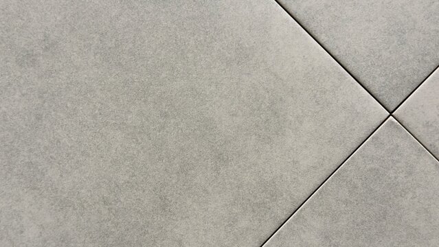 Minimalist light grey stone tile texture background with diagonal grout lines and clean matte surface