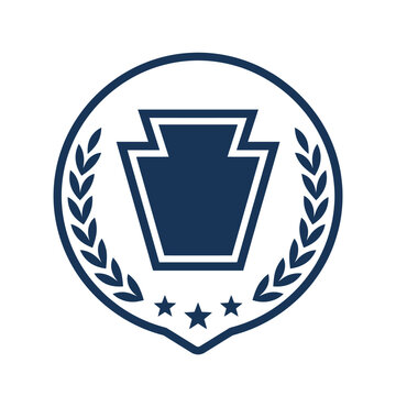 Keystone shield logo inside a navy blue laurel wreath.