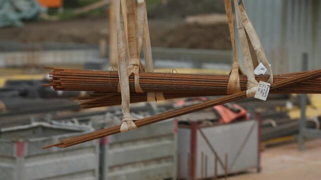 Suspended Rebar Bundle Transported by Crane at Construction Site