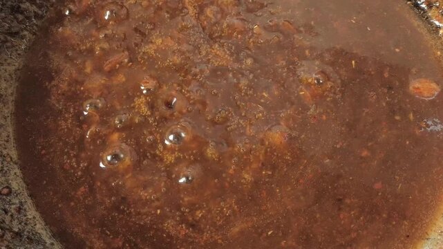 Cooking tamarind sauce in pan, indoor Chiangmai Thailand.