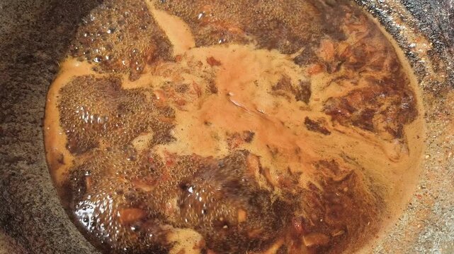 Cooking tamarind sauce in pan, indoor Chiangmai Thailand.
