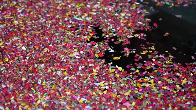 View of red chili flakes and dried peppers spread across a dark ground for sun drying in Bogura, Rajshahi Division, Bangladesh.