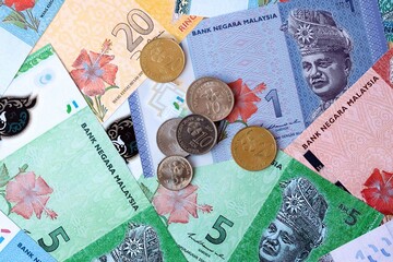 Malaysian ringgit money banknotes and coins on table. Malaysia cash bills of MYR currency © Viktor