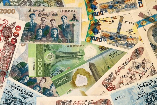 Algerian dinar money bills in pile on table. Algeria DZD currency cash close up
