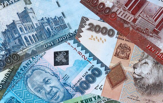 Tanzanian shilling money bills in pile on table. Tanzania TZS currency cash close up