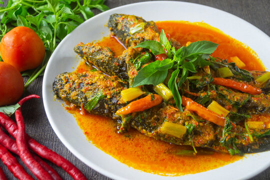 Woku ikan lele served in white plate, Woku is a typical Manado food from North Sulawesi province, Indonesia.