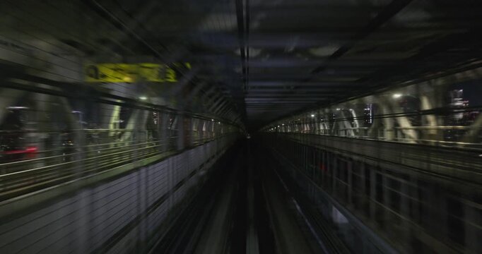 Train goes through city at night,  concept of speed, time lapse