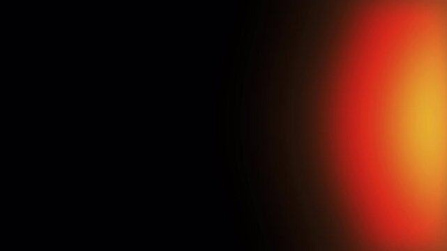 Abstract warm light leak effect with soft orange, red, and yellow gradients fading into a dark background. Glowing lens flare abstract backdrop. Orange yellow light leak bloom on dark background