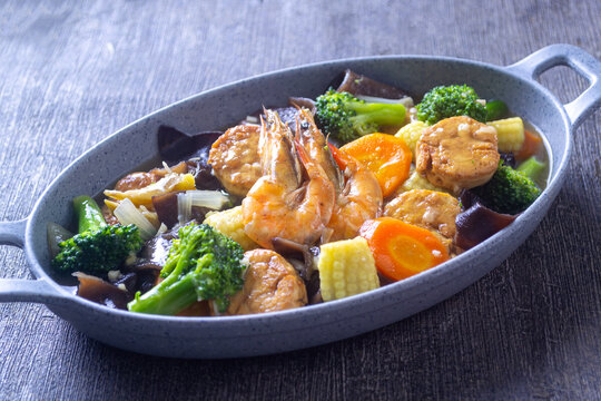 Chinese style sapo tahu seafood and fresh vegetables on a plate