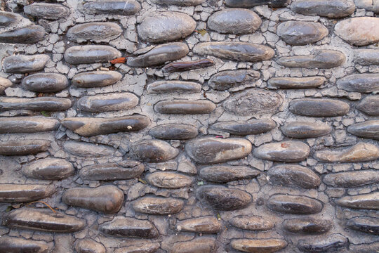 Rough stones form a weathered, textured surface